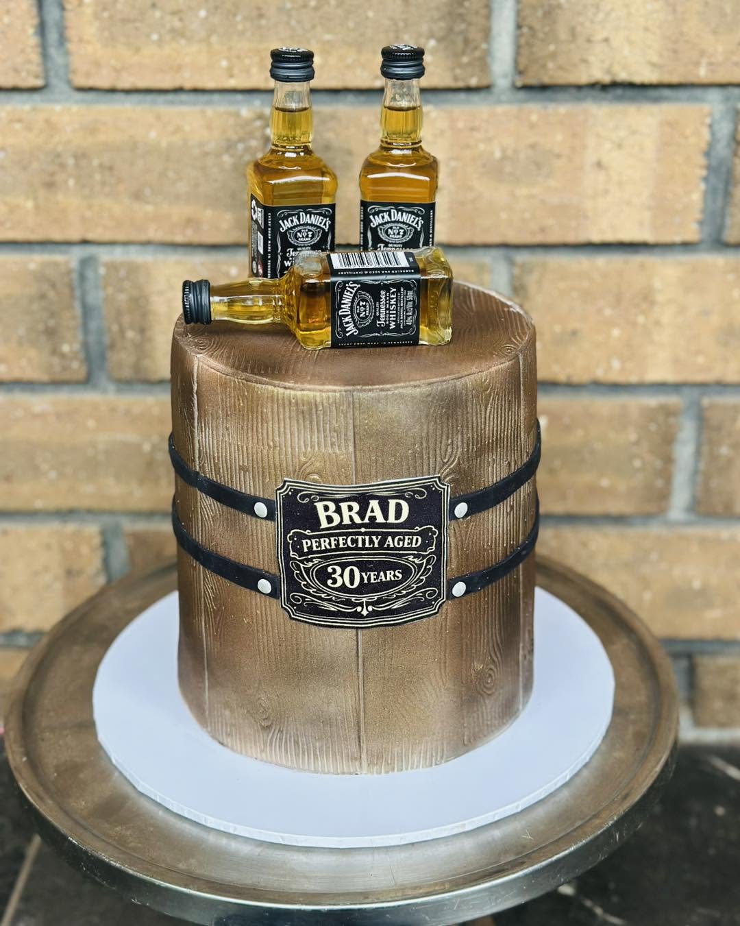Jack Daniels whiskey barrel birthday cake for Brad with mini bottle toppers and wood grain fondant